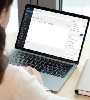 A woman offering article content writing services in India is typing on a laptop.