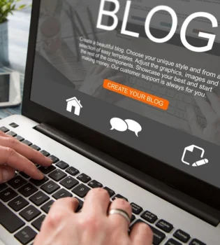 A person starts a blog by typing on a laptop implies the need for a blog writing service provider.