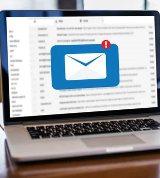 E-newsletter writing services in India are represented by a mail icon on the laptop.