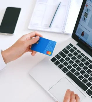 Ecommerce writing services are represented by a woman using a credit card to shop online.