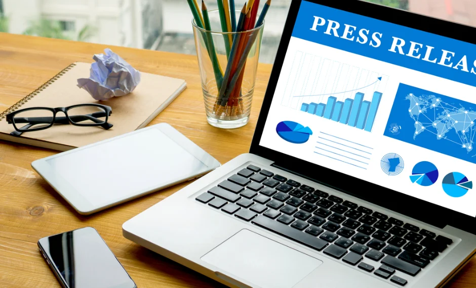 Professional press release writing services for companies and groups appear on a laptop screen.