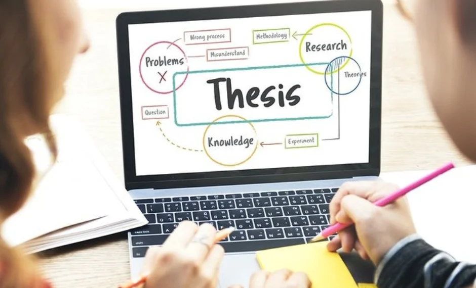 On a laptop, writers are doing thesis writing with research, knowledge, and problem solving steps.